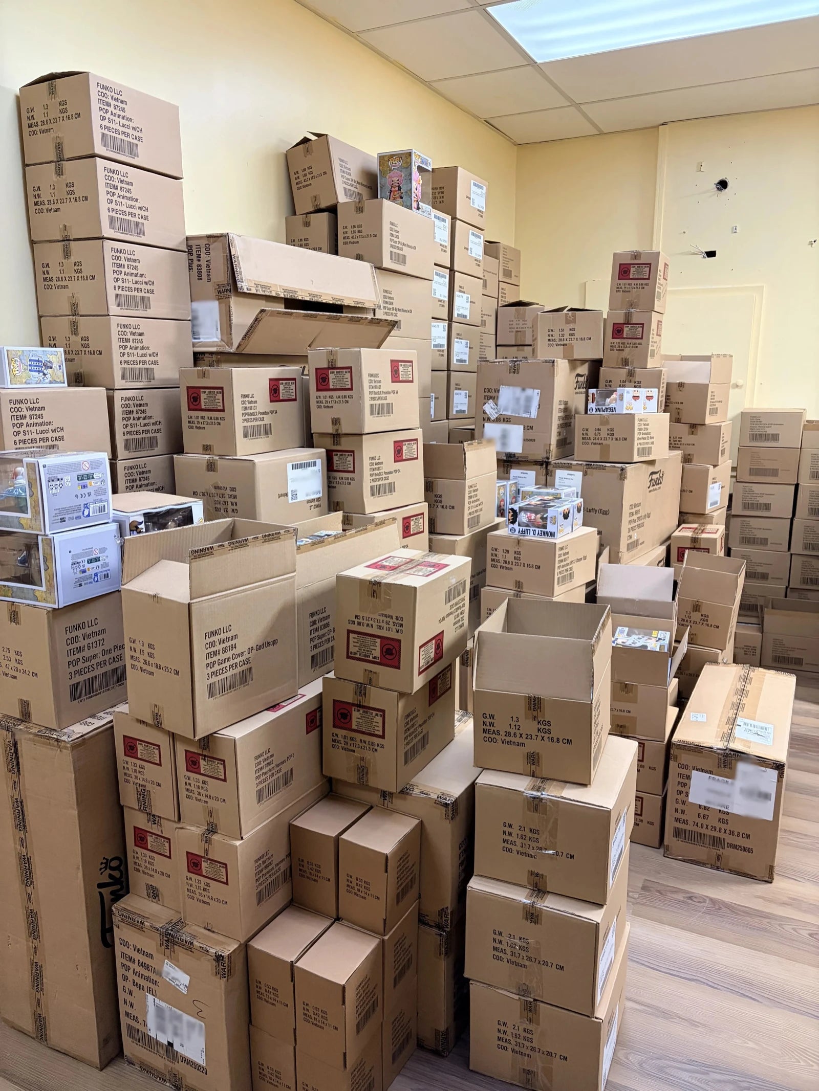 Hand-inspecting a Funko Pop and placing it in a premium 0.5mm protector at our GTA warehouse